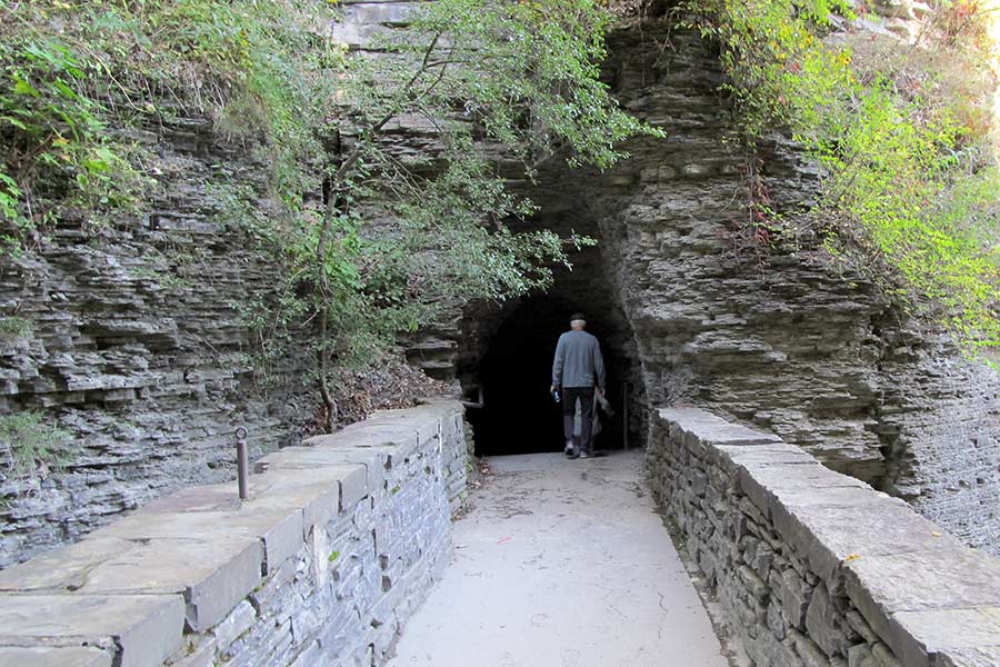Man walking into tunnel at Watkins Glen State Park