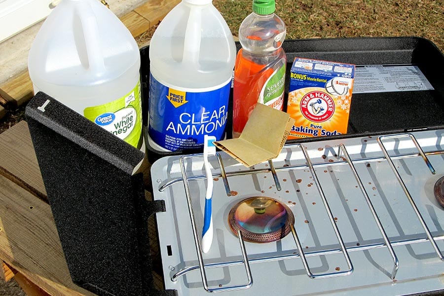 Camp stove with vinegar, ammonia, soap, and baking soda in background