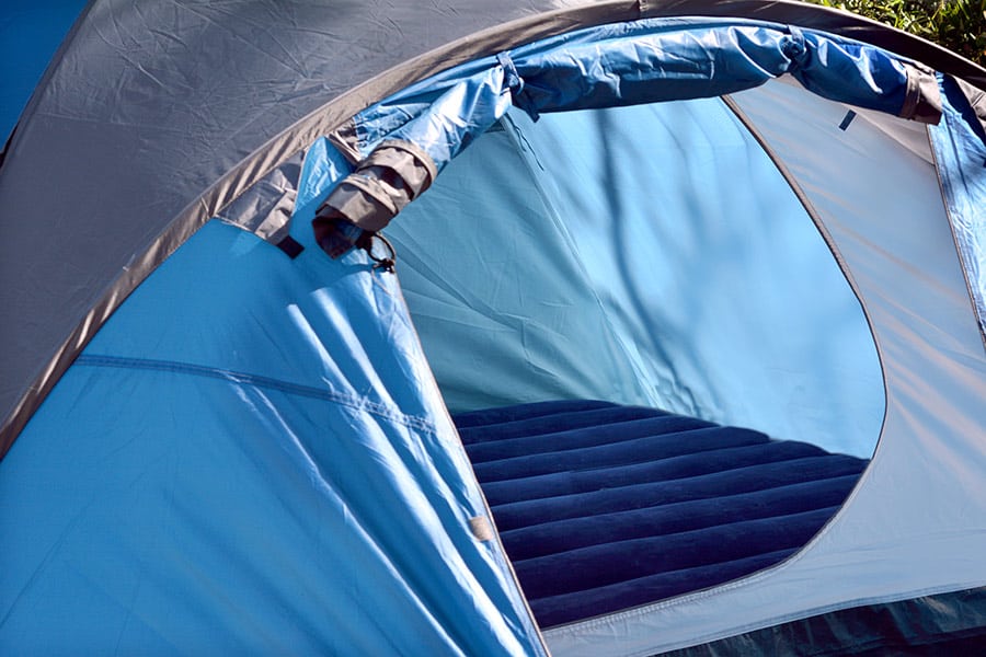 Blue tent with a blue inflated mattress inside