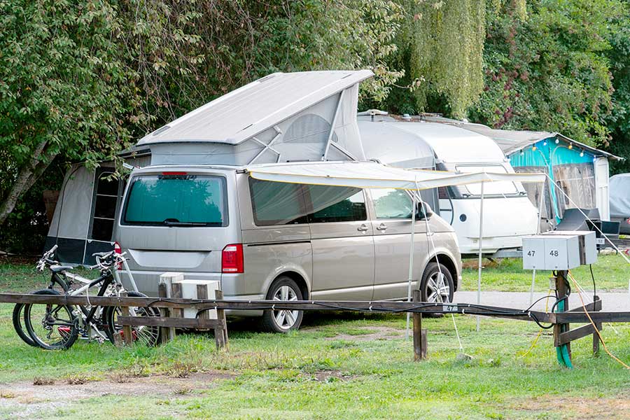Grey pop top van at campground