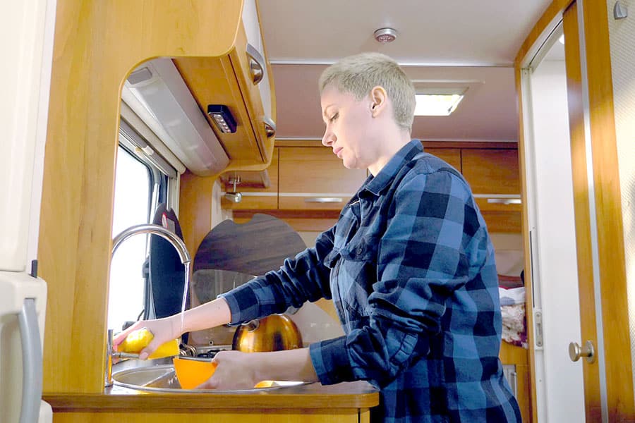 Woman washing dishes in RV sink