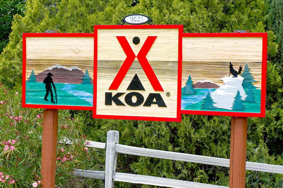Colorful painted wood KOA campground sign