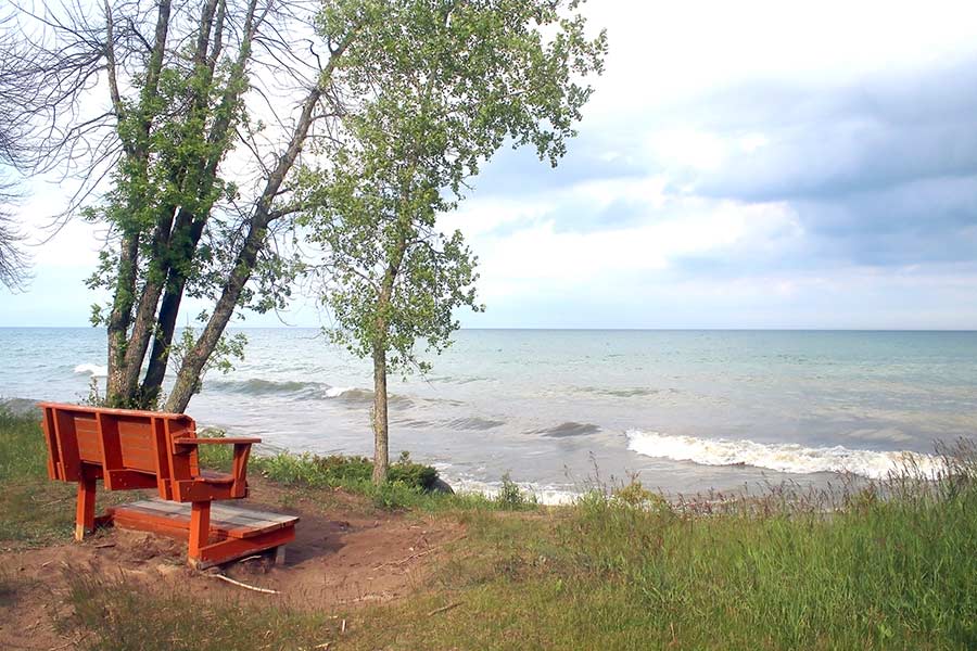 Wooden bench with view of Lake Michigan at Harrington Beach State Park