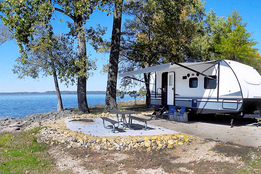 Camper trailer parked near lakeshore