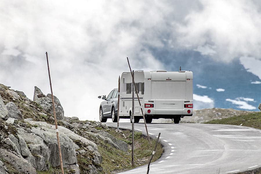 Pick-up truck pulling a camper trailer